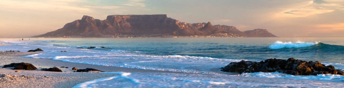Coastal ocean view with Table Mountain rising above Cape Town shoreline